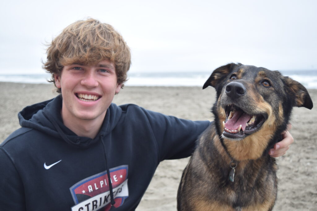 A picture of me with my dog, Ellie at the beach.